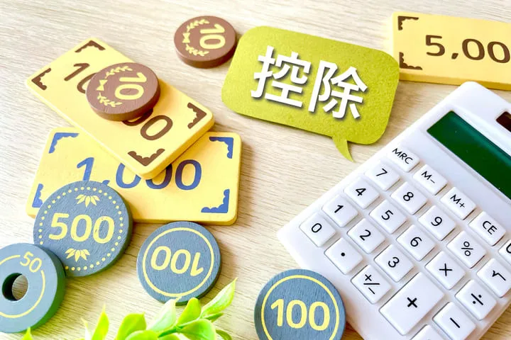 控除と書かれた府だとお金のおもちゃと計算機の画像